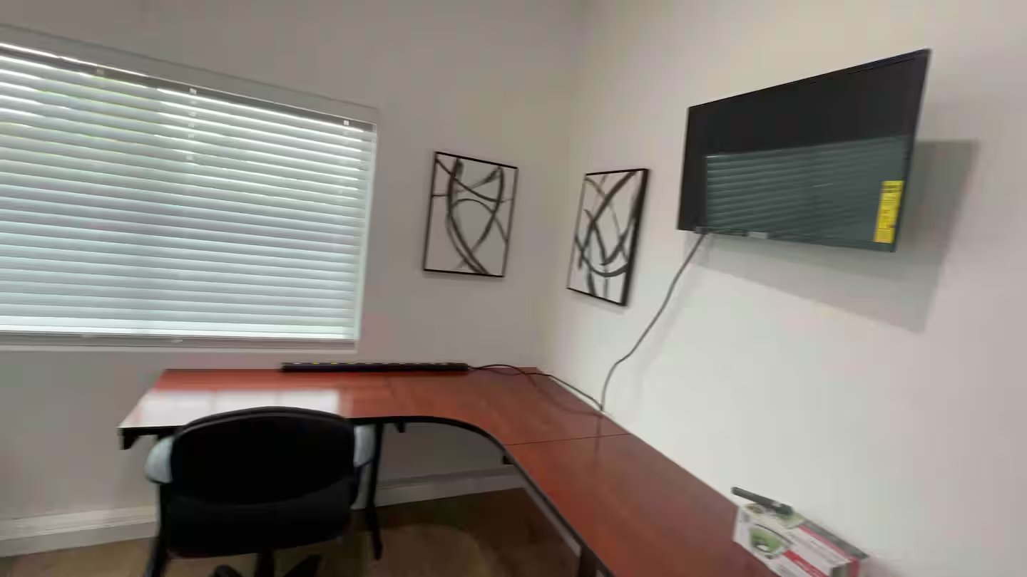 Dedicated workspace with mounted TV at Serenta corporate rental in Tracy CA